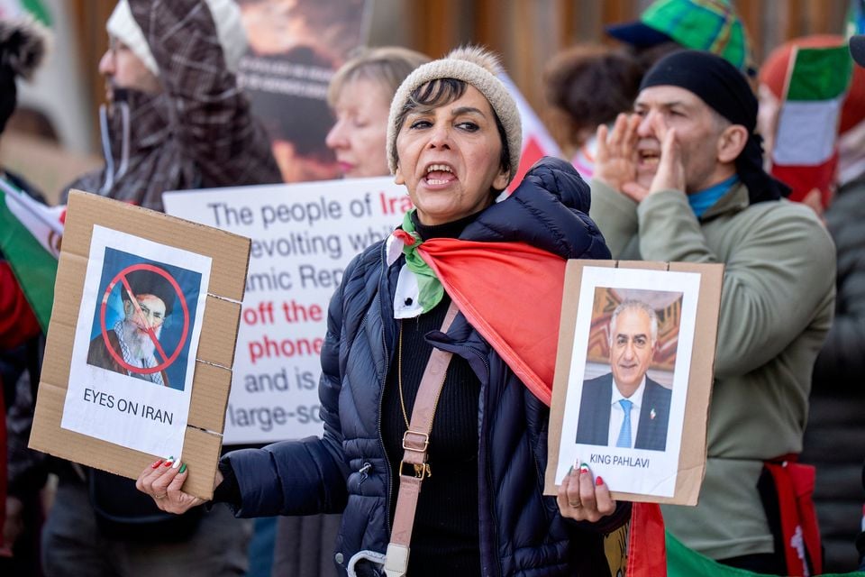 People take part in a protest outside the Scottish Parliament in Edinburgh, calling for a regime change in Iran (PA)